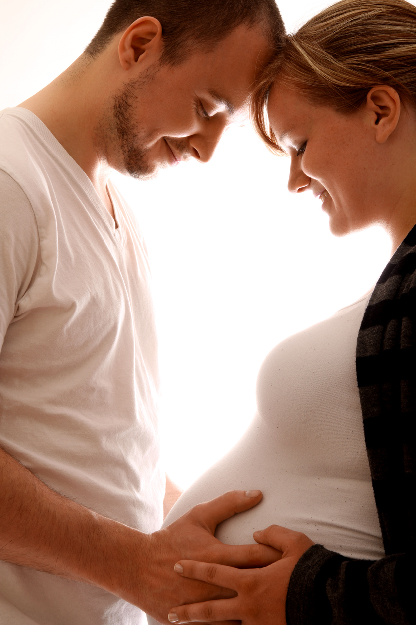 Young couple embrace upcoming pregnancy with joy
